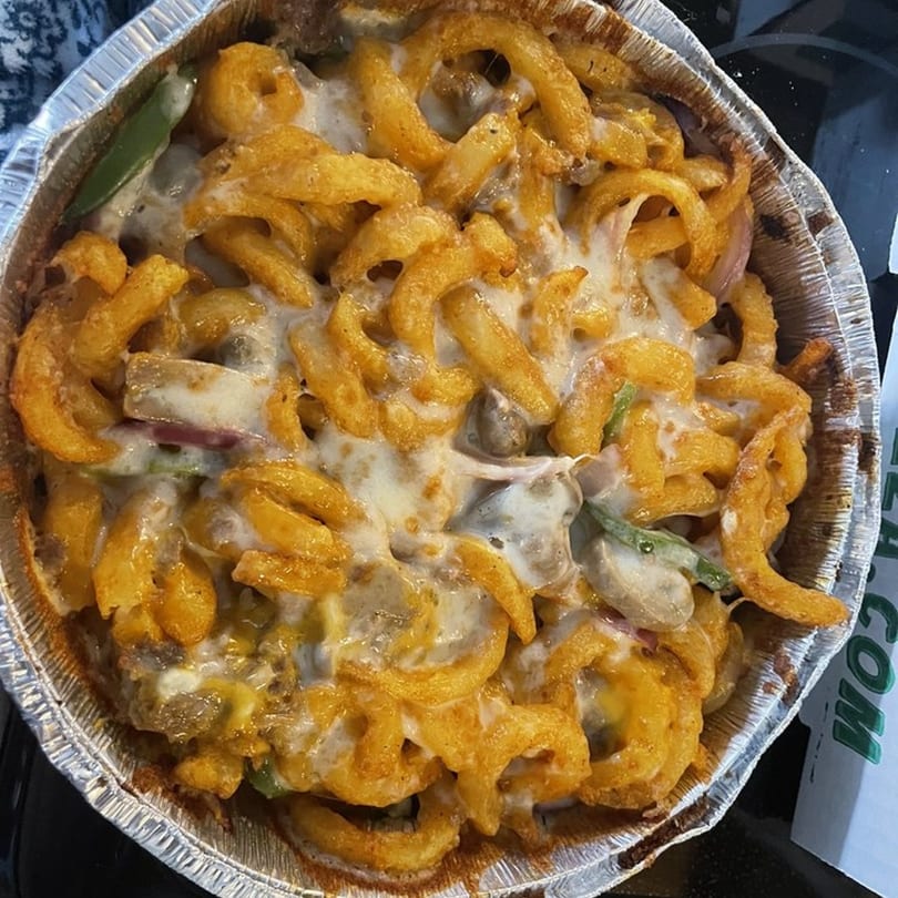 Gumby's Pizza's Pokey Stix, curly fries covered in melted cheese, mushrooms, and green peppers.